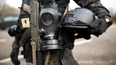 A member of the Boogaloo Boys stands outside of the Oregon State Capitol building during a nationwide protest supporting former US president Donald Trump, January 17, 2021. AFP