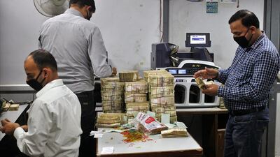 Employees count old 500-rupee notes at a bank in Jammu, India, on November 11, 2016. Mukesh Gupta / Reuters
