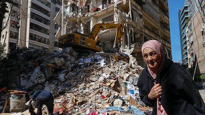 A woman walks past a destroyed residential building the day after an Israeli airstrike in the Ain Mreisseh neighborhood of Beirut. EPA
