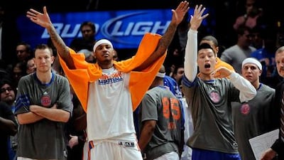 Carmelo Anthony, centre, was the New York Knicks hero as he stands with the injured Jeremy Lin, right.