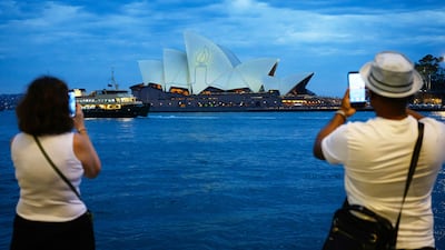 Sydney Opera House illuminated by candlelight on a national day of reflection honouring the victims of the Bondi Beach terrorist attack in Australia. AFP