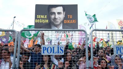 A supporter of Turkey's main pro-Kurdish Peoples' Democratic Party (HDP) holds a portrait of their jailed former leader and presidential candidate Selahattin Demirtas during a campaign event in Istanbul. REUTERS/Huseyin Aldemir