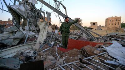 A Houthi fighter checks the damage caused by a US air strike on Sanaa. American forces have intensified attacks on rebel-held areas of Yemen. AFP