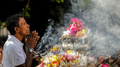 Sri Lankan Buddhist devotees take part in religious observance on a full moon day at a temple in the Kelaniya suburb of Colombo, Sri Lanka. EPA