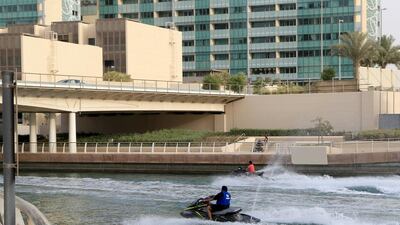 Jet-ski riders race each other up and down the waterway towards Yas Marina. (Ravindranath K / The National)