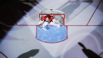 Karri Ramo of the Calgary Flames prepares himself in his net before a game against the San Jose Sharks. Derek Leung / Getty Images