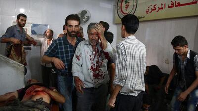 People receive treatment at a makeshift hospital in the rebel-held area of Douma, east of the Syrian capital Damascus, following air strikes by government planes on August 16, 2015, that killed at least 80. Abd Doumany / AFP