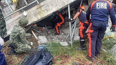 Rescuers retrieve a resident from a collapsed building in La Trinidad, Benguet province, after a 7.0 magnitude earthquake hit the Philippines. EPA