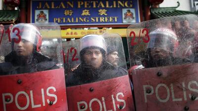 Malaysian riot police guard Petaling Street from pro-government 'red shirt' protestors during a rally in Kuala Lumpur on September 16, 2015. Fazry Ismail/EPA