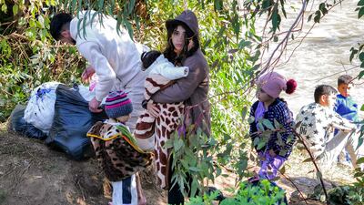 Displaced people cross the Nahr Al Kabir into Lebanon from Syria's western Latakia province. Latakia has witnessed much of the violence. AFP