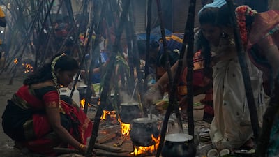 Tamil women cook special food to celebrate the harvest festival of Pongal in Dharavi, Mumbai. AP