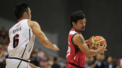 Manny Pacquiao dribbles around a defender on Sunday in his PBA debut with Kia-Sorento basketball club. Romeo Ranoco / Reuters