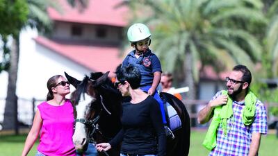 Relationships are built on the field, and not just between humans, during sessions at Riding for the Disabled Dubai. Reem Mohammed / The National