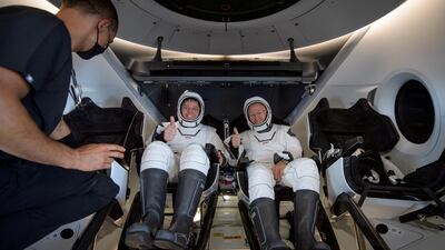NASA astronauts Robert Behnken, left, and Douglas Hurley are seen inside the SpaceX Crew Dragon Endeavour spacecraft onboard the SpaceX GO Navigator recovery ship shortly after having landed in the Gulf of Mexico off the coast of Pensacola, Florida, U.S. REUTERS