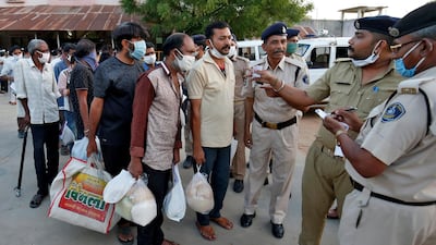 Police officers speak with prisoners after they were released on parole outside the Sabarmati Central Jail during a 21-day nationwide lockdown to slow the spreading of coronavirus disease (COVID-19), in Ahmedabad, India. REUTERS