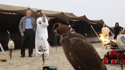 Sheikh Mohammed bin Zayed, Crown Prince of Abu Dhabi and Deputy Supreme Commander of the Armed Forces, talks to US president George W Bush as Sheikh Mohammed bin Rashid, Vice President and Ruler of Dubai, and Condoleezza Rice, the US Secrertary of State, look on at a private dinner in the desert. Philip Cheung / Abu Dhabi Media Company / January 13, 2008