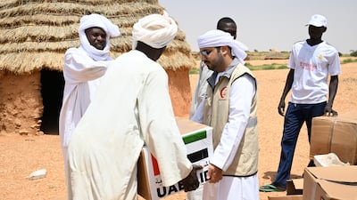 The UAE humanitarian team based in Amdjarass distributes food parcels to Sudanese refugees in the village of Herakaia, Chad. Wam