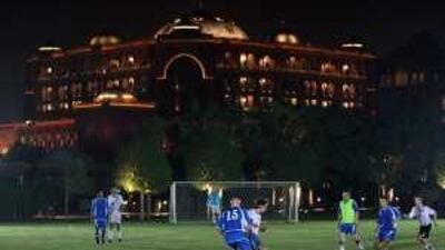 The Emirates Palace hotel is the backdrop for a football match between the Abu Dhabi Strollers and Emirates Palace last October.