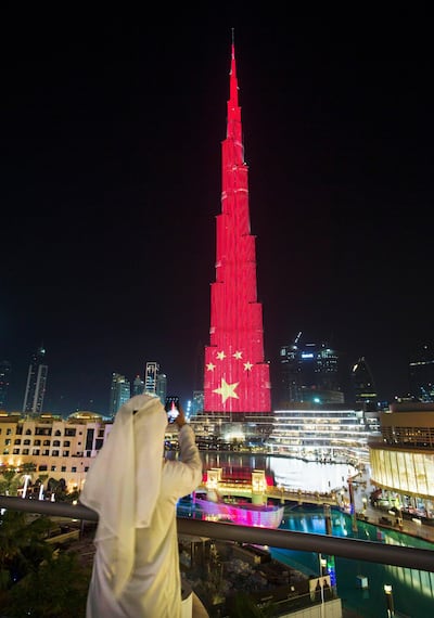The Burj Khalifa is lit up in colours of the Chinese flag to mark Xi Jinping’s visit to the UAE this week. Leslie Pableo for The National