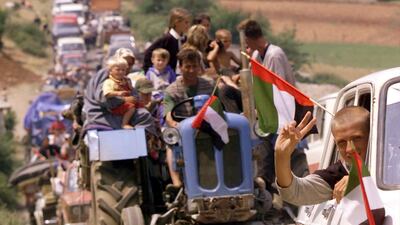 Thousands of refugees make their way home across the border from Albania into Kosovo Wednesday on June 16, 1999. There were more than 120,000 refugees in the Kukes area. David Guttenfelder / AP