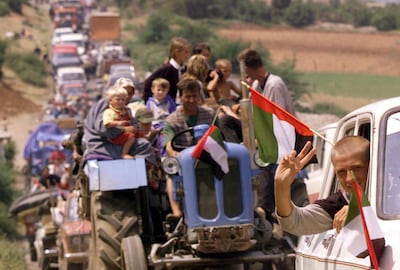 Thousands of refugees from the camp make their way home from Albania into Kosovo on June 16, 1999. David Guttenfelder / AP