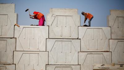 Labourers in New Delhi. While most major countries will see expansion slow, India and the UAE set to buck the trend. Reuters