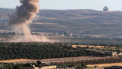 Smoke billows following reported regime air strikes on the village of Kafr Sajna in the southern outskirts of Syria’s Idlib province on August 16, 2019. AFP