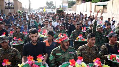 Iraqis attend the funeral of a member of the Shiite Badr Brigade, who died near Tikrit in fighting against ISIL, on April 8, 2015 in the southern Iraqi city of Basra. Haidar Mohammed Ali/AFP Photo