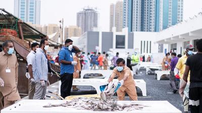 Fishermen load tables at the Ajman fish market on April12, 2020. Reem Mohammed / The National