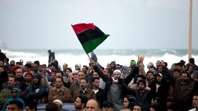 An old flag is waved during a 2011 demonstration in Benghazi before the fall of Muammar Qaddafi.