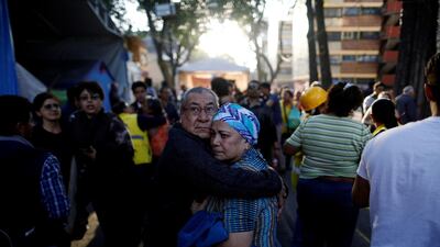 People react after an earthquake shook buildings in Mexico City. Edgard Garrido / Reuters