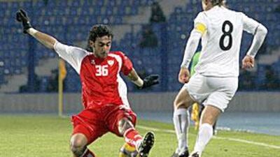 UAE's Yousef Al Hammadi is all over the ball before Server Djeparov of Uzbekistan can challenge him during their Asian Cup qualifying match in Tashkent.