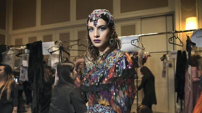 Amid a frenzy of activity, a model prepares to take to the runway. Courtesy Mark Ganzon