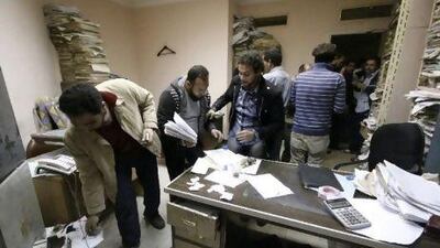 Egyptians search an office in the state security agency building in Nasr City, Cairo.