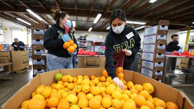 Volunteers Jailene Cruz and Genesis Maldonado sort food at the Los Angeles Regional Food Bank distribution center in Los Angeles, California. Reuters