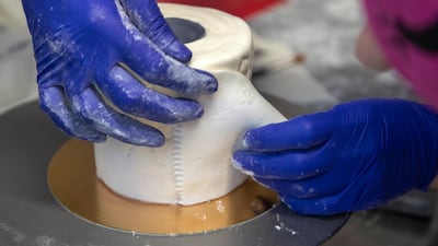 Baker Uliana Timoreeva creates a toilet paper cake, in Helsinki, Finland. EPA