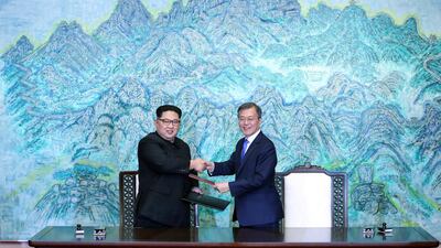 North Korean leader Kim Jong Un, left, and South Korean President Moon Jae-in shake hands after signing a joint statement at the border village of Panmunjom in the Demilitarised Zone, South Korea. Korea Summit Press Pool via AP