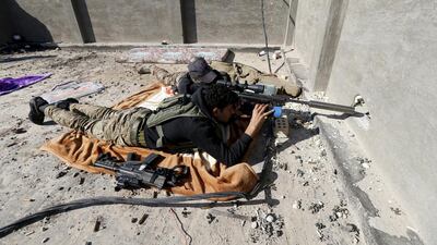 An Iraqi security forces sniper looks through the scope of his rifle as he guards in the city of Ramadi, January 16, 2016. A UN report says nearly 19,000 civilians were killed in a 21-month period. REUTERS/Thaier Al-Sudani