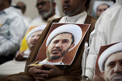 A supporter holds a portrait of Sheikh Ali Salman, head of Al Wefaq, during a protest against his arrest after the movement was banned in 2016. AFP