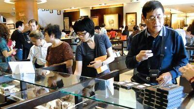 A Chinese man buys souvenirs at a counter of the National Palace Museum in Taipei. Patrick Lin / AFP