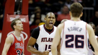 Atlanta Hawks' Al Horford, center, celebrates after making a basket and drawing a foul in the third quarter of an NBA basketball game against the Chicago Bulls, Monday, Dec. 15, 2014, in Atlanta. Atlanta won 93-86. (AP Photo/David Goldman)