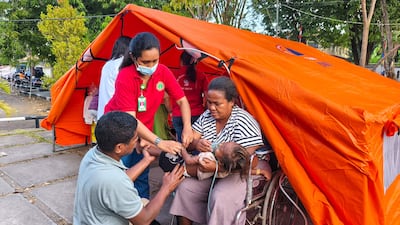 A child is treated at a medical tent set up amid fears of aftershocks on Flores Island. AFP