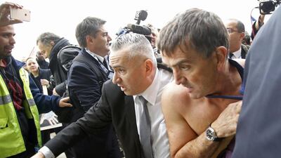 A shirtless Xavier Broseta is evacuated by security after employees interrupted an Air France meeting in Roissy, near Paris, France, October 5, 2015. Jacky Naegelen / Reuters