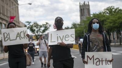 Protesters march with three placards stating "Black Lives Matter" in the aftermath of widespread unrest following the death of George Floyd on June 1, 2020 in Philadelphia, Pennsylvania. Getty
