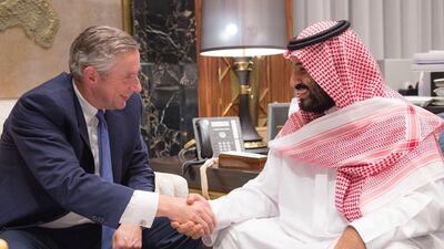 Saudi Crown Prince Mohammed bin Salman shakes hands with Klaus Kleinfeld, who has been appointed the prince's adviser. Saudi Press Agency