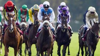French jockey Olivier Peslier, centre, starts his celebration aboard Solemia after winning the Prix de l'Arc de Triomphe for the fourth time.