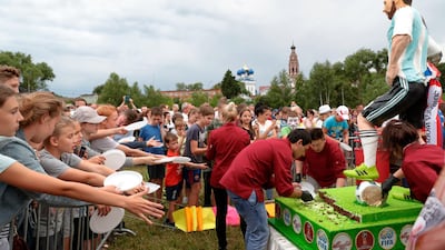 Children wait at a celebration to mark Lionel Messi's birthday near Argentina's training camp base. AP