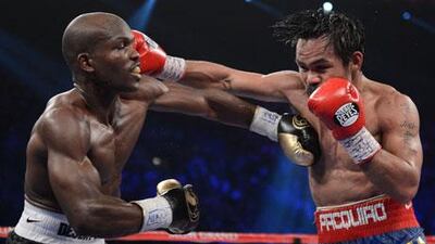 Timothy Bradley and Manny Pacquiao exchange punches during their controversial WBO welterweight title fight.