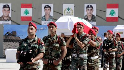 Lebanese soldiers carry the coffins of 10 comrades who were taken hostage in 2014 by ISIL and whose remains were found along the Syrian border, during a funerary ceremony at the ministry of defence in Yarze, on the eastern outskirts of Beirut, on September 8, 2017. Anwar Amro / AFP