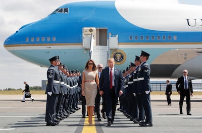 Donald Trump and first lady Melania Trump walk across the tarmac after stepping off Air Force One as they arrive at London's Stansted Airport on July 12, 2018. AP Photo